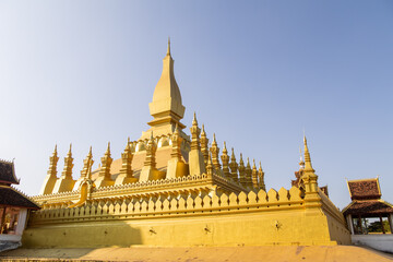 Naklejka premium Pha That Luang bright golden stupa of buddhist temple in vientiane laos