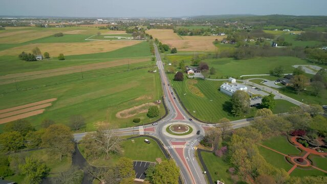 Traffic circle with vehicles traveling on it. Aerial drone view.
