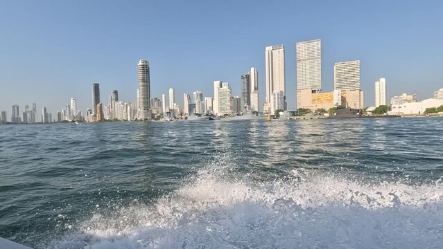 Scenic boat ride along Bocagrande, Cartagena, Colombia,  blue skies overhead and city skyline as your backdrop