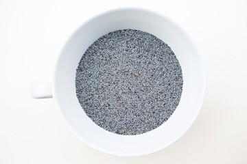 Blue poppy seeds birds eye view in white ceramic bowl with handle