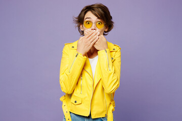Young sad surprised shocked woman she wears yellow shirt white t-shirt casual clothes glasses cover...