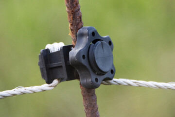detail of an electric fence with clips and fixings