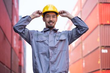 Portrait Asia logistic engineer man worker or foreman working at container site	