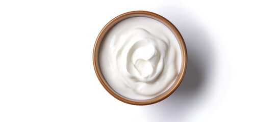 A bowl of Greek-styled sour cream on a white background