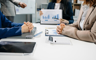 Businessman and team analyzing financial statement Finance task. with smart phone and laptop and  tablet.