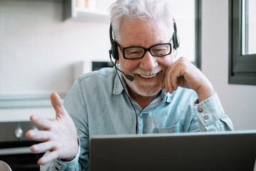 Video call concept.  Senior caucasian businessman smiling working online watching webinar podcast...