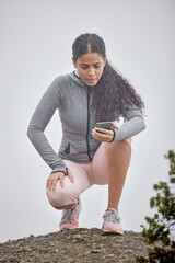 Mountain, hiking and woman exercise with phone to check stats or time of workout in nature. Runner,...