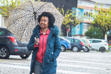 happy free afro woman posing on the street