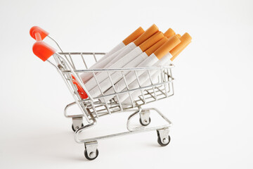 Cigarette in shopping cart, cost, trading, marketing and production, No smoking concept.