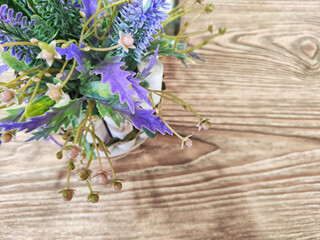 Colorful bouquet of gentle spring flowers placed on a rustic wooden table. Background, place for...