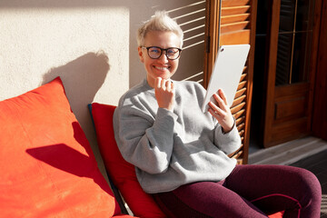 50S Older Mature Middle Aged Stylish European Woman Smiling and Holding Digital Tablet. Video...