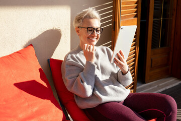 50S Older Mature Middle Aged Stylish European Woman Looking At  Digital Tablet. Video Conference,...