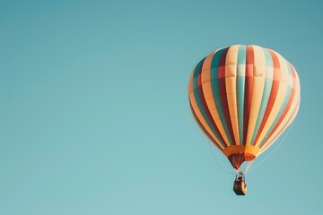 Whimsical Striped Hot Air Balloon Floating Peacefully Across a Clear Blue Sky on a Serene Aerial Adventure