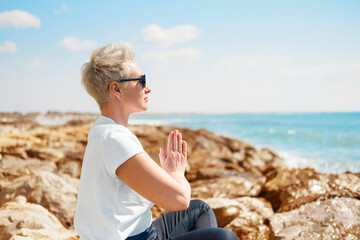 Middle Aged Female Doing Yoga Exercises. Mindfulness Zen Spiritual Meditation Tips. Kundalini Yoga....