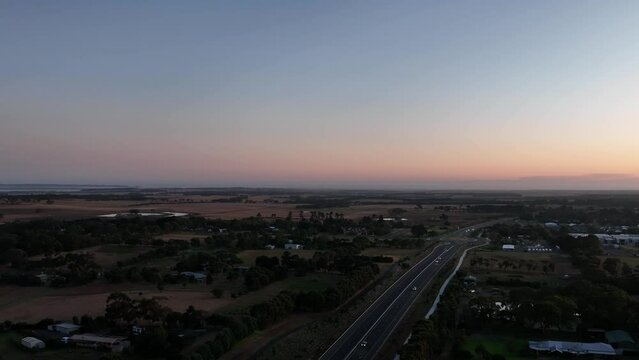 Sunset over highway with cars on it