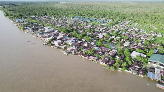Aerial shot of Atrato river and residential areas on its banks in Choco, Colombia