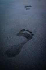 soles of feet, footprints on the beach sand