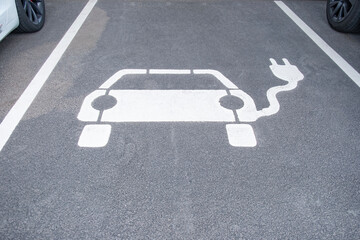 white electric vehicle sign painted on asphalt, charging station, Power Charger ev in Europe,...