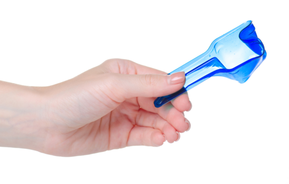 Measuring spoon for washing powder in hand on white background isolation