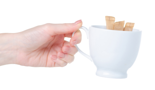 Sugar sticks in hand and white cup on white background isolation - Powered by Adobe