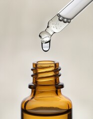 oil dripping from dropper white background.