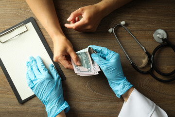The doctor is given illegal money, the concept of corruption in medicine.