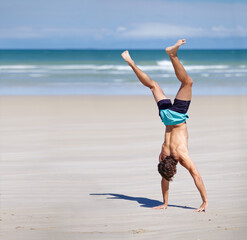 Man, calisthenics and body at beach sand for exercise with summer, health and mockup. Male athlete,...