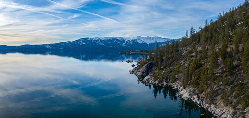 Forest and snowy mountains on a calm blue Lake Tahoe. Incline Village-Crystal Bay, Nevada, United...
