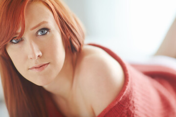 Woman, portrait and redhair with closeup in bedroom with makeup for beauty with blue eyes in...