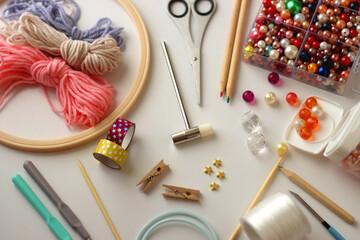 Various craft supplies on white background. Supplies for jewelry making, drawing and needlework. Selective focus.