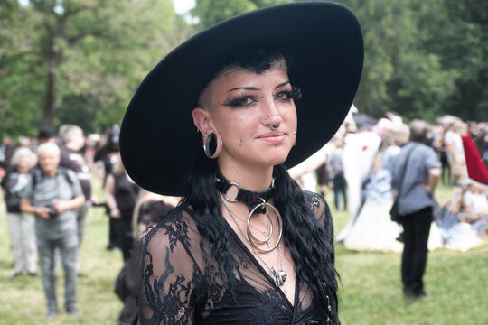 Young, smiling, female goth in black outfit on the annual Wave Gotik Treffen (Wave Gothic Meeting) in Leipzig, victorian picnic, Clara-Zetkin-Park