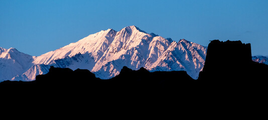 Pink colors at sunrise over snow-capped Himalayan mountains near Leh in India's Ladakh region