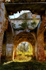 An arched passage in an abandoned temple with a collapsed roof. At the end of the passage is the light of hope.
