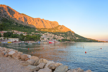 Scenic view of Omis on the Adriatic seacoast, Dalmatia, Croatia. Cozy town with beach and greenery surrounded by Dinara mountains, outdoor travel background, tourist resort
