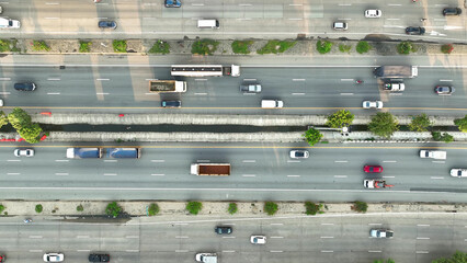 A mesmerizing drone shot captures the intercity motorway's rhythmic flow, where cars move like...