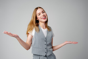 Joyful Young Blonde Woman Smiling against gray background