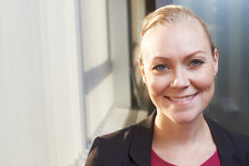 Smile, business and face of woman at office window with opportunity, HR consultant or confident project manager. Human resources, support and professional businesswoman in happy portrait at workplace