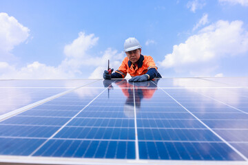 Engineer einspects solar panels, angle view blue sky backgrounds,