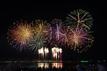 PATTAYA, CHONBURI, THAILAND, Fireworks at Pattaya bay, Pattaya national Fireworks Festival contest, November of every Year, Beautiful of bright light fireworks Show in middle sea, for postcard  - obrazy, fototapety, plakaty