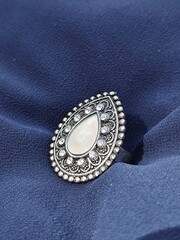 silver metallic ring with white and silver stones on it. Traditional ethinc silver steel ring