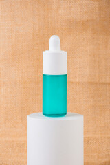 Blue glass cosmetic bottle, Skin care or sunscreen cosmetic on wood background.