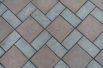 Backdrop - geometric pavement made of grey and brown concrete tiles
