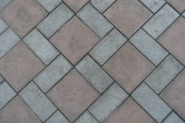 Top view of geometric pavement made of grey and brown concrete tiles