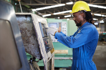 engineer or technician checking and control lathe machine in the factory