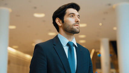 Portrait imaged of professional business man looking around at mall. Executive manager standing at...