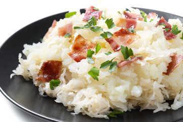 Slovak potato dumplings halusky with steamed sauerkraut and bacon isolated on white background. Close up