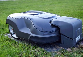 The robotic lawnmower is charging at the charging station