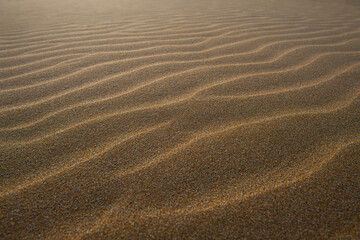Beautiful sand waves or sand waves caused by the wind. Wind action constantly changes the height,...