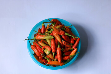red cayenne pepper in a green bowl. spicy flavored vegetables