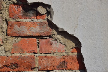 The texture of the old wall. The destruction of the plaster, the brick is visible. Close-up.